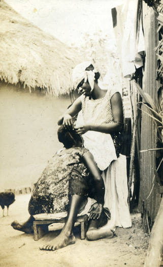 mother braiding daughters hair