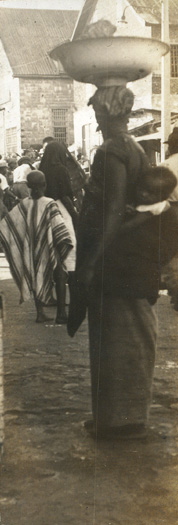 Photograph of woman carrying bowl on her head